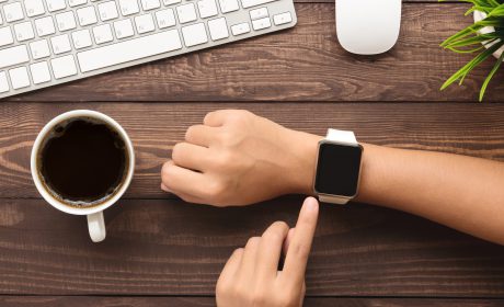 Hand,Using,Smartwatch,On,Desk,Top,View Apple watch